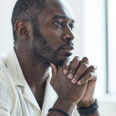Close-up of a person's hands in a meditative pose.